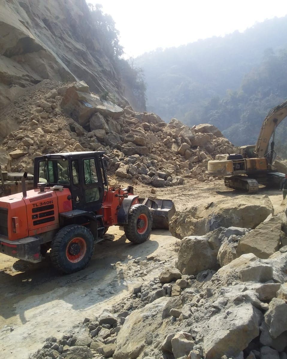 Earth excavators at work at the site clearing the debris. (Photo Courtesy: Dimapur police)